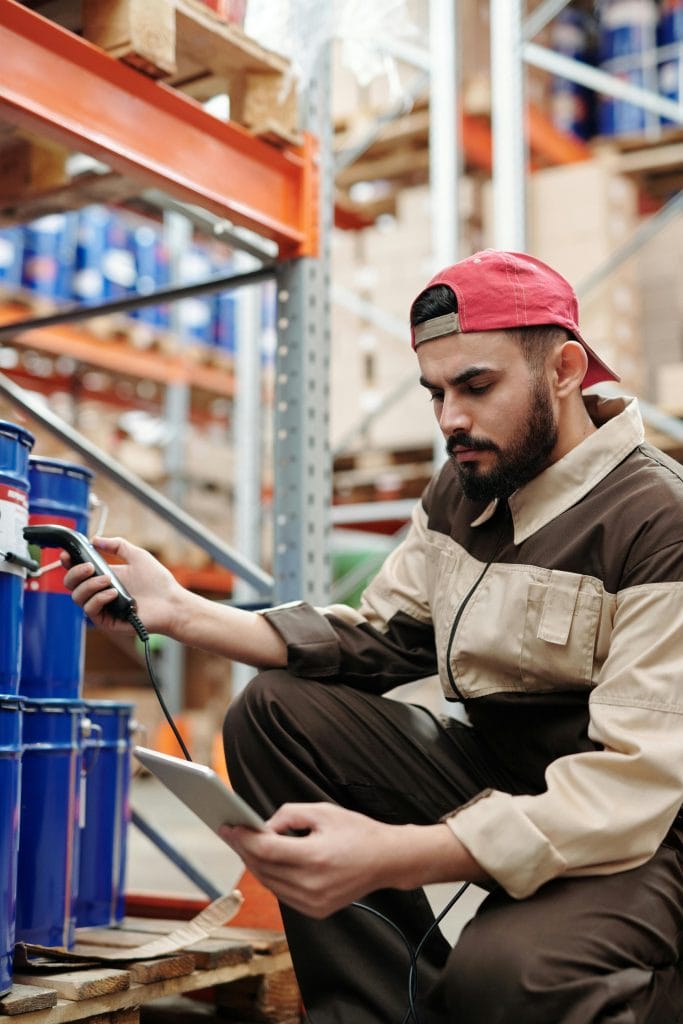Warehouse worker using a digital tablet for inventory technology
